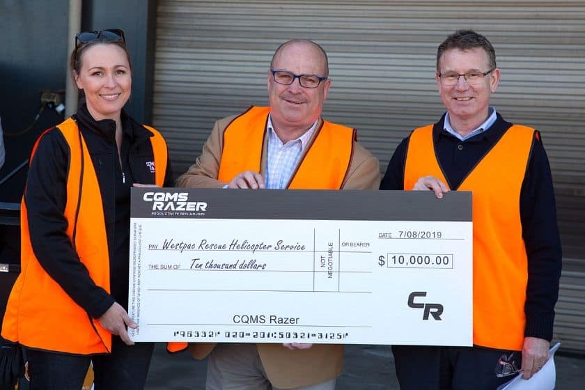 Kristy Boyce (CQMS Razer), Westpac Rescue Helicopter Service CEO Richard Jones and CQMS Razer CEO John Barbagallo holding a large check for Westpac