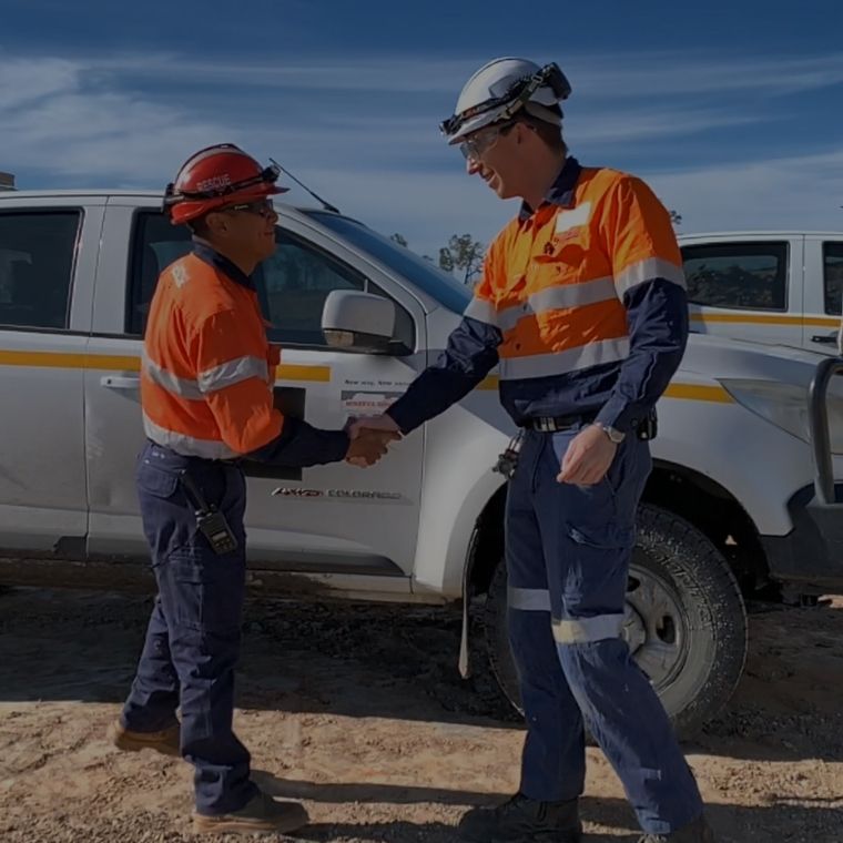 Shaking hands on a mine site