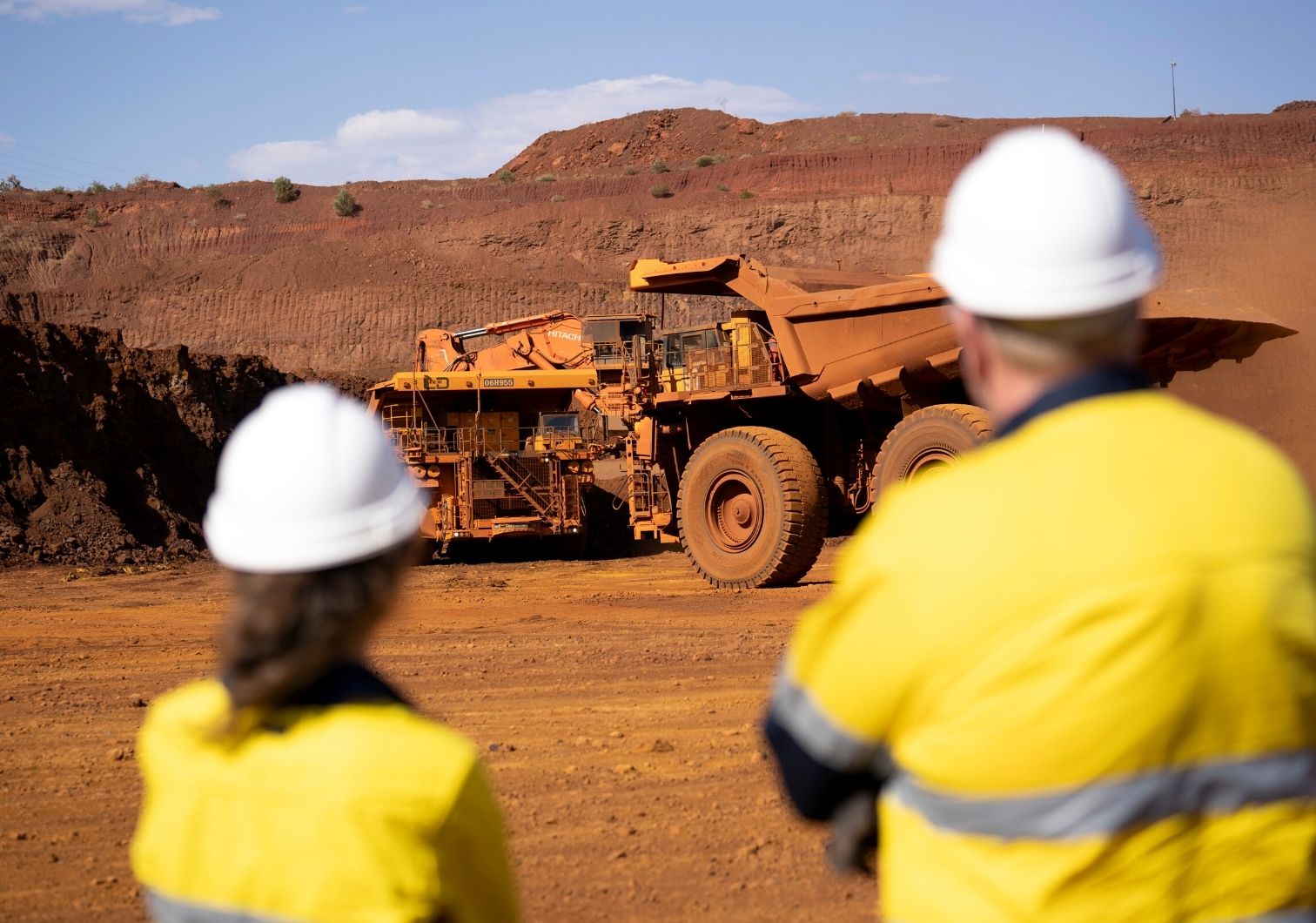 Mining Safety - Two staff watching mining equipment operate